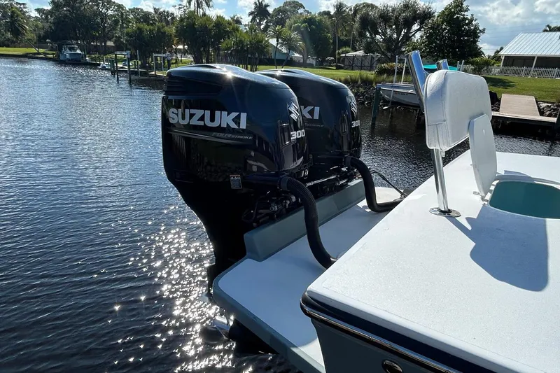Slide: The Image of 2006 Whitewater 28 boat docked on a sunny day with cloudy sky. - 2