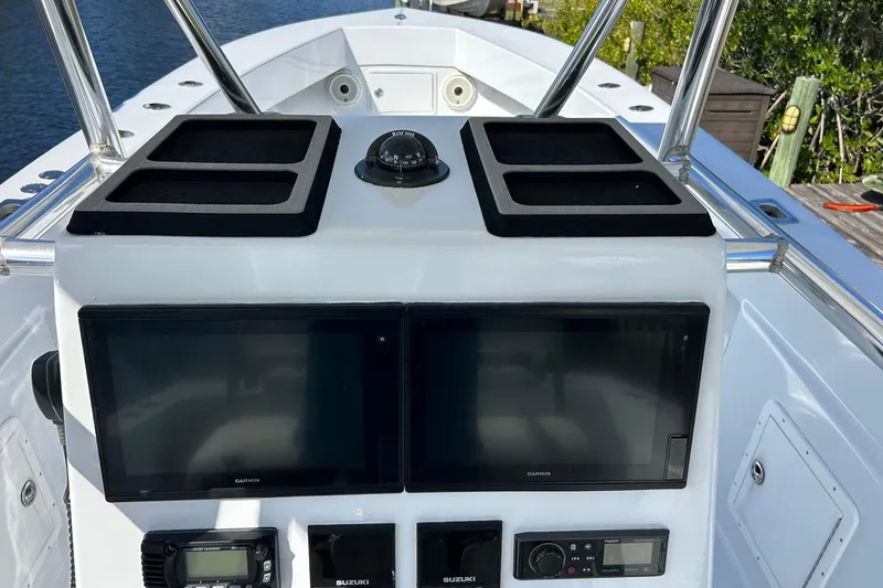 Slide: The Image of 2006 Whitewater 28 boat interior with cushioned seating and steering wheel. - 20