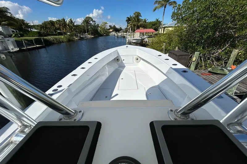 Slide: The Image of 2006 Whitewater 28 boat interior view with chrome railings and scenic waterway background. - 22