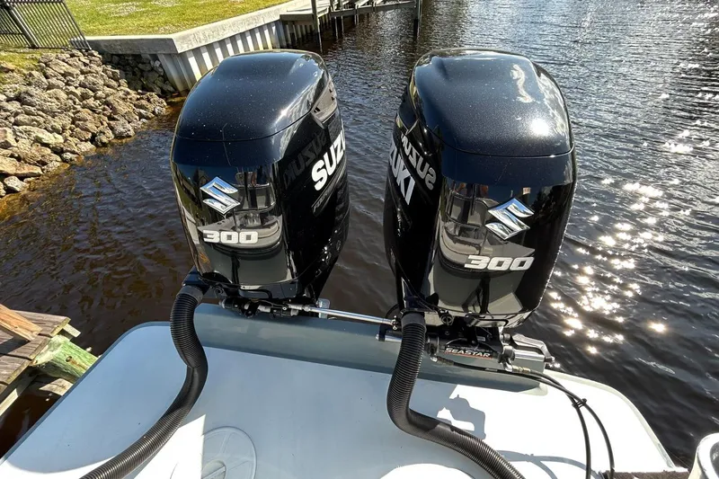 Slide: The Image of 2006 Whitewater 28 boat interior with seating, docked by the water. - 24