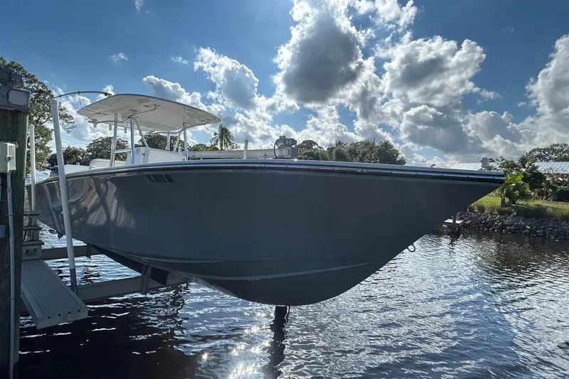 Slide: The Image of 2006 Whitewater 28 boat docked under a bright, cloudy sky. - 27