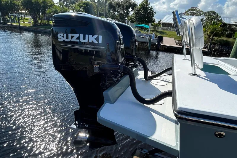 Slide: The Image of 2006 Whitewater 28 boat with twin Suzuki 300 outboard engines on a sunny day. - 3