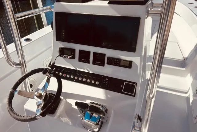 Slide: The Image of 1989 Whitewater 28 boat console with steering wheel and control panel. - 40