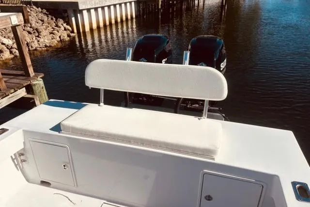 Slide: The Image of 1989 Whitewater 28 boat with dual engines, docked by a wooden pier. - 42