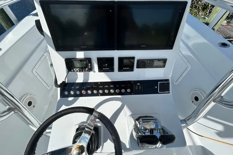 Slide: The Image of 2006 Whitewater 28 boat with dual engines, docked by a calm waterfront. - 9