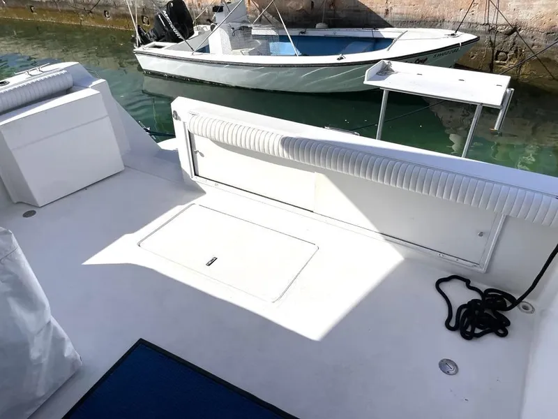 Slide: The Image of 1998 Navigator 53 yacht deck with seating and moored boat in background. - 10