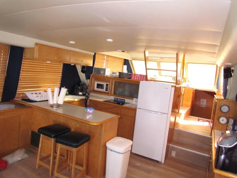 Slide: The Image of Interior of a 1998 Navigator 53 yacht with kitchen and seating area. - 12