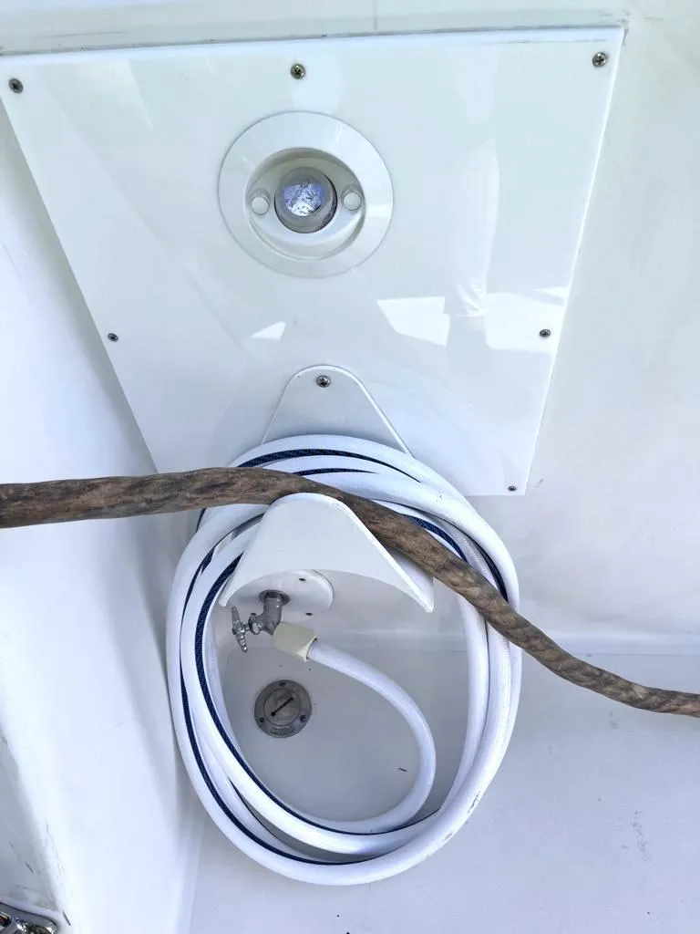 Slide: The Image of Coiled hose and light fixture on 1998 Navigator 53 boat. - 13