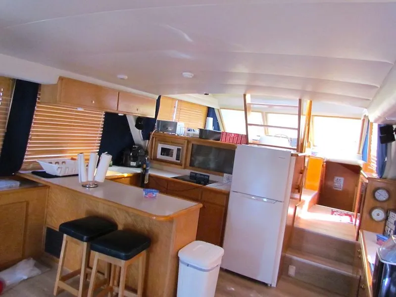 Slide: The Image of Interior of a 1998 Navigator 53 yacht with kitchen and seating area. - 14