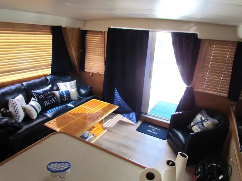Slide: The Image of Interior of 1998 Navigator 53 yacht with cozy seating and nautical decor. - 17