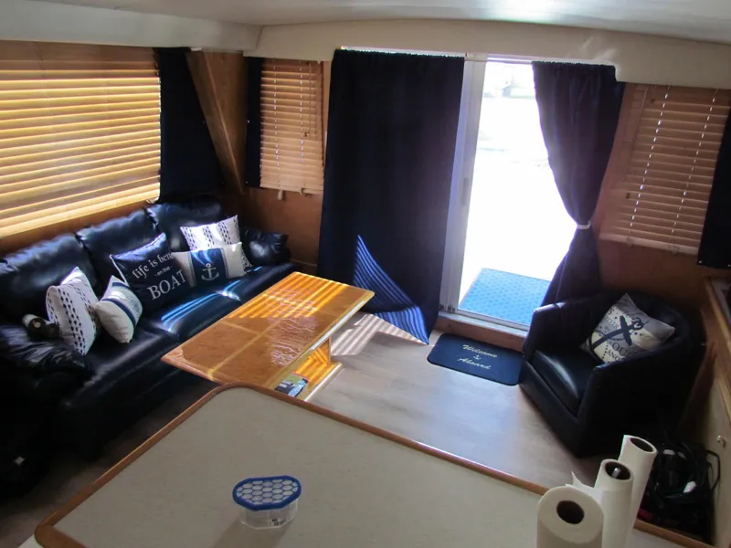 Slide: The Image of Interior of 1998 Navigator 53 yacht with cozy seating and nautical decor. - 18