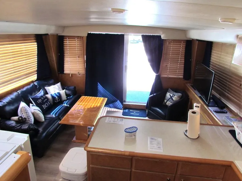 Slide: The Image of Interior of a 1998 Navigator 53 yacht with cozy seating and modern amenities. - 19