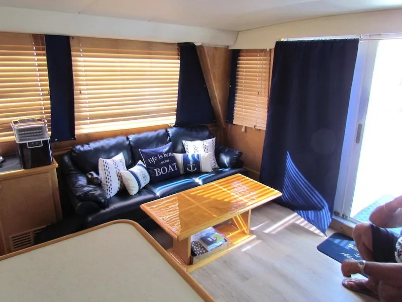 Slide: The Image of Interior of 1998 Navigator 53 yacht with cozy seating, nautical decor, and wooden blinds. - 22