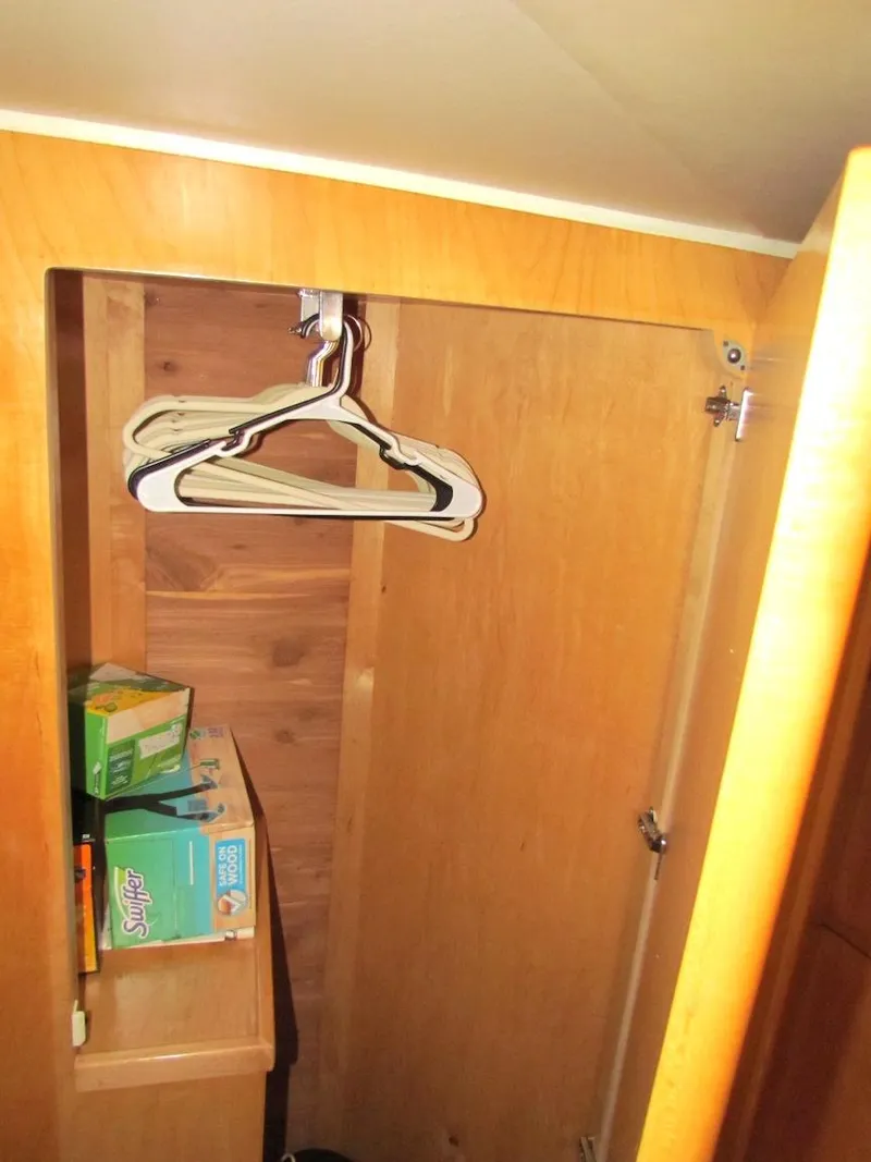 Slide: The Image of Wooden closet interior with hangers and storage boxes on a Navigator 53, 1998 model. - 26