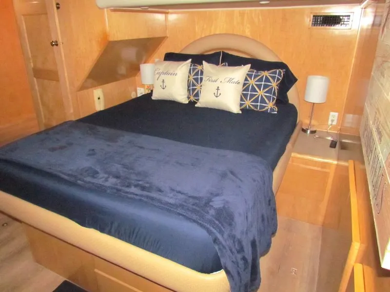 Slide: The Image of Luxurious bedroom interior of 1998 Navigator 53 yacht with navy bedding and nautical decor. - 30
