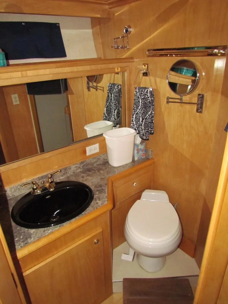 Slide: The Image of Bathroom interior of a 1998 Navigator 53 yacht with wood accents and modern fixtures. - 32