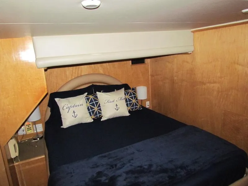 Slide: The Image of Cozy bedroom in 1998 Navigator 53 yacht with nautical-themed pillows and wooden paneling. - 34