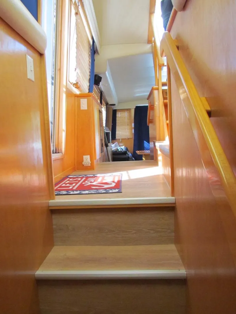 Slide: The Image of Interior stairs of a 1998 Navigator 53 yacht with wooden finish and natural lighting. - 35