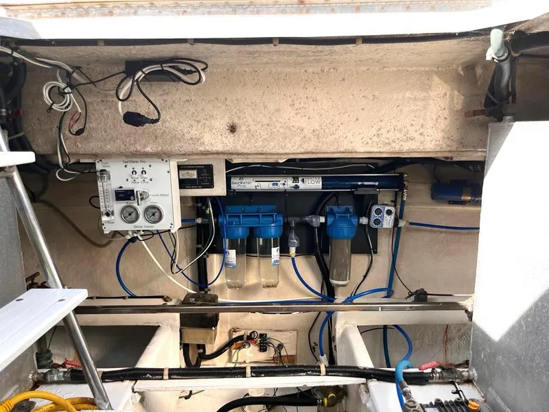 Slide: The Image of Engine compartment of a 1998 Navigator 53 yacht, showcasing mechanical and electrical components. - 36