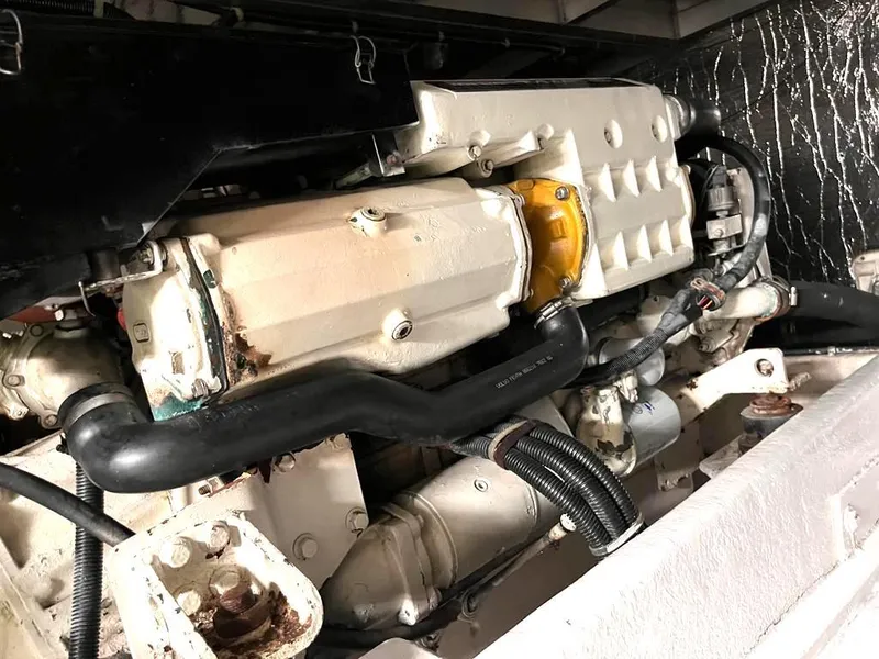 Slide: The Image of Engine of a 1998 Navigator 53 yacht, showcasing mechanical components and hoses. - 38