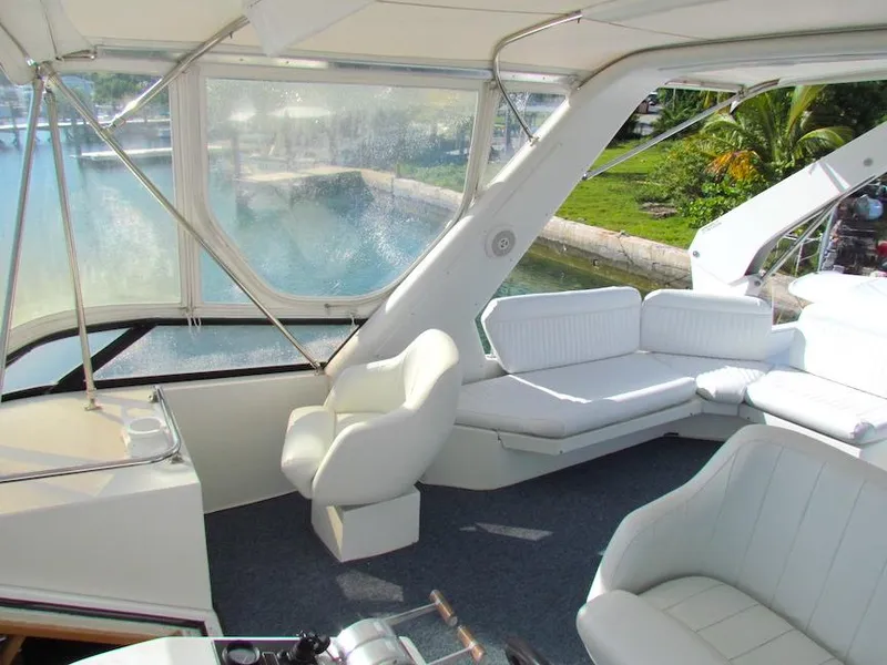 Slide: The Image of Interior of 1998 Navigator 53 yacht with white seating and waterfront view. - 4