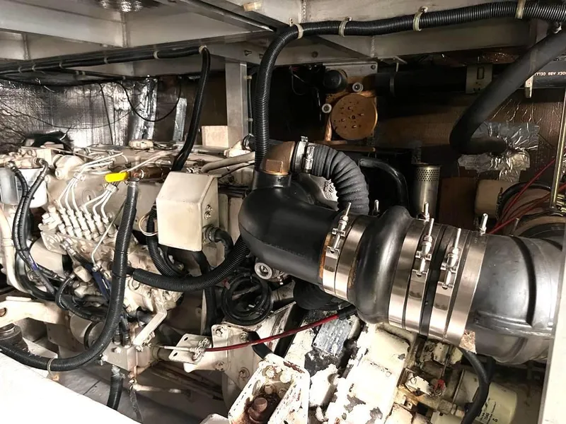 Slide: The Image of Engine compartment of a 1998 Navigator 53 yacht, showcasing mechanical components and wiring. - 42