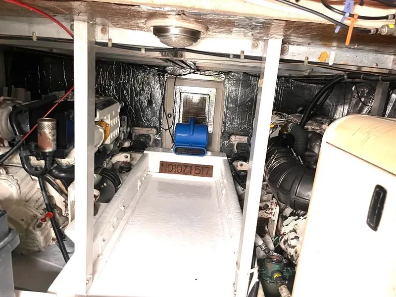 Slide: The Image of Engine room of a 1998 Navigator 53 yacht, featuring mechanical components and wiring. - 43
