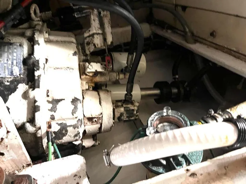 Slide: The Image of Engine compartment of a 1998 Navigator 53 yacht, showing mechanical components and hoses. - 44