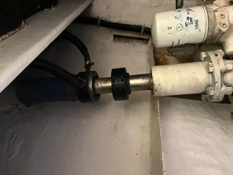 Slide: The Image of Engine room component of a 1998 Navigator 53 yacht, featuring a metal shaft and filter. - 45