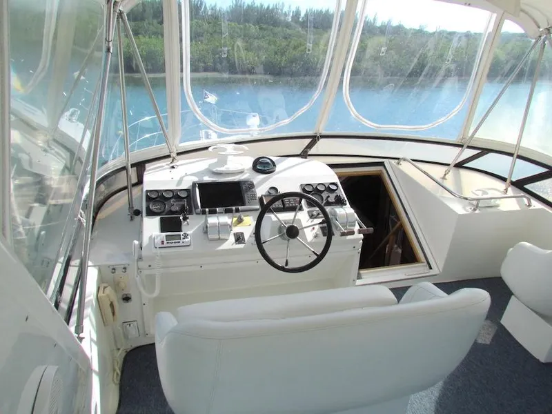Slide: The Image of Interior view of 1998 Navigator 53 yacht cockpit with steering wheel and control panels. - 5