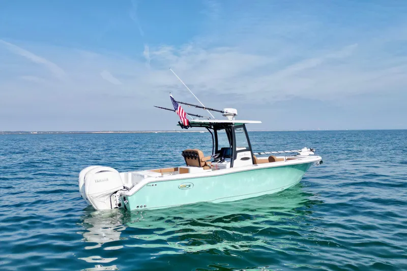Slide: The Image of 2024 Sea Hunt Gamefish 25 boat on open water, featuring sleek design and Yamaha engine. - 3