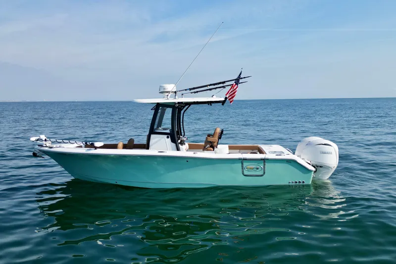 Slide: The Image of 2024 Sea Hunt Gamefish 25 boat on calm ocean waters, featuring sleek design and modern equipment. - 5