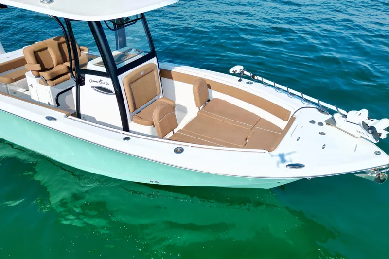 Slide: The Image of 2024 Sea Hunt Gamefish 25 boat on clear blue water, featuring spacious seating and modern design. - 7