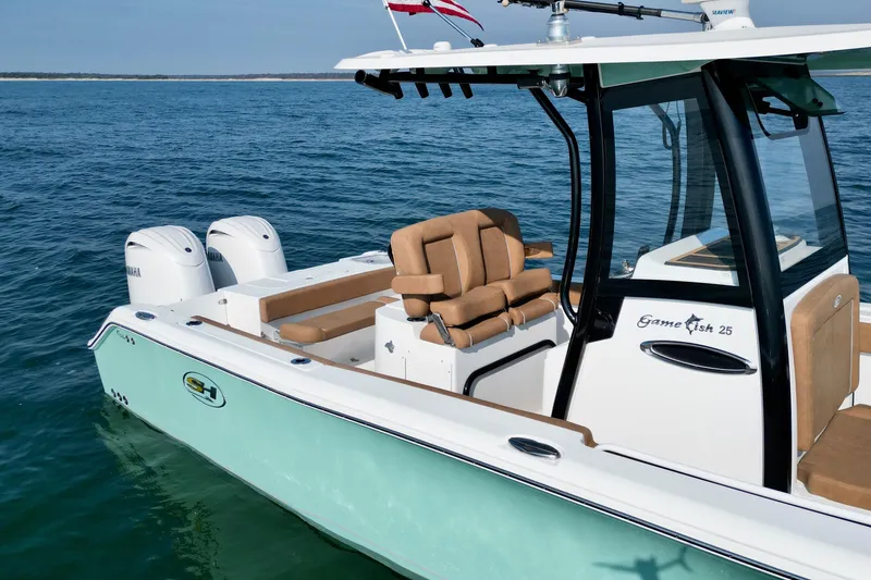Slide: The Image of 2024 Sea Hunt Gamefish 25 boat on water, featuring dual Yamaha engines. - 9