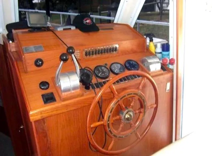 Slide: The Image of Mainship 430 Trawler 2000 helm with wooden wheel and navigation instruments. - 12