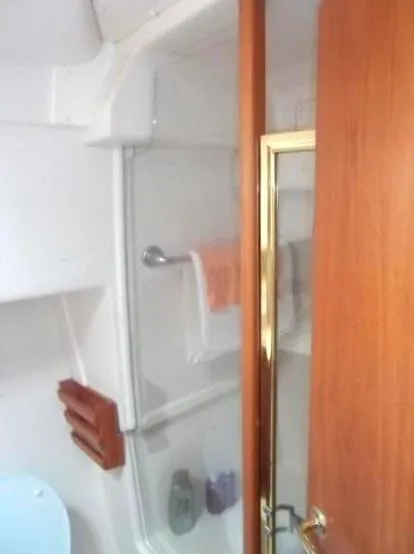 Slide: The Image of Bathroom interior of 2000 Mainship 430 Trawler with glass shower door. - 13
