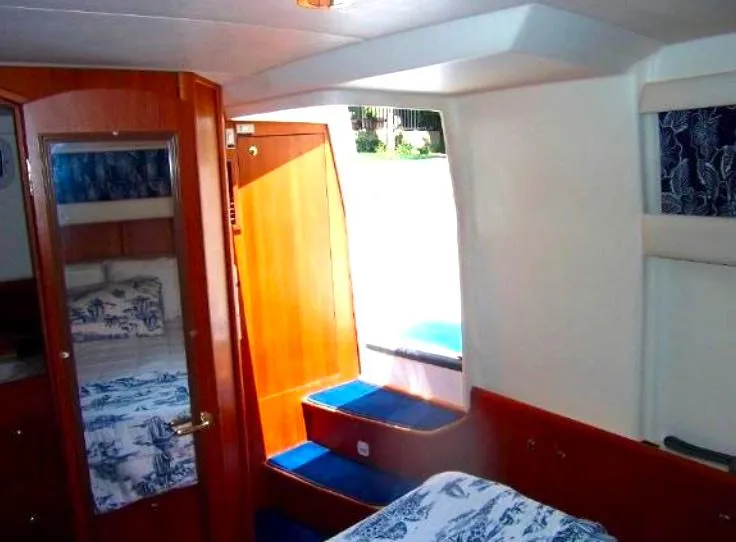 Slide: The Image of Interior of 2000 Mainship 430 Trawler with wood accents and nautical decor. - 17