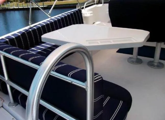 Slide: The Image of Mainship 430 Trawler 2000 interior with striped seating and white table. - 5