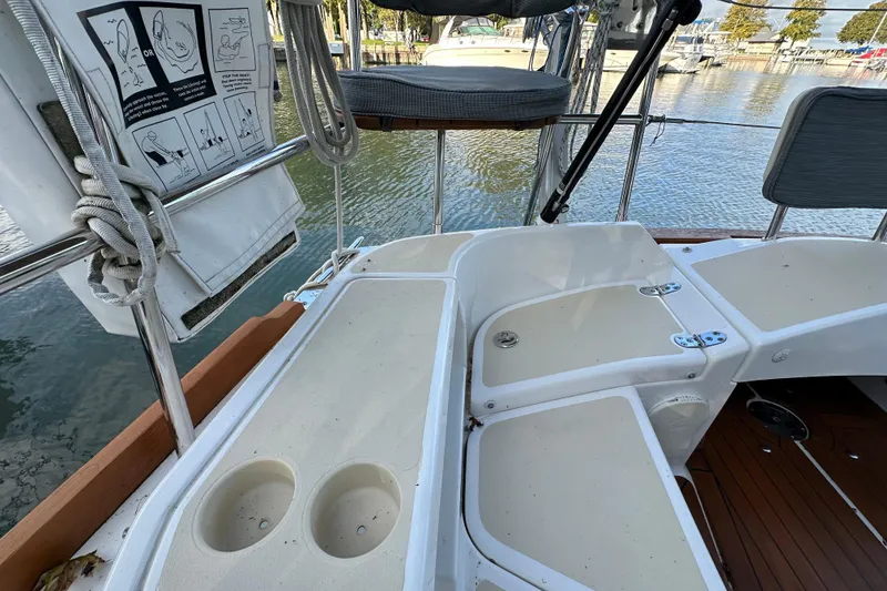 Slide: The Image of 2017 Tartan 4300 sailboat cockpit with seating and cup holders, docked at marina. - 11