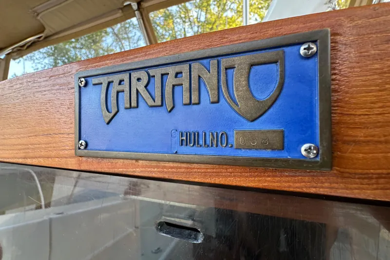 Slide: The Image of Tartan 4300 sailboat nameplate, hull number 038, on wooden surface, 2017 model. - 13