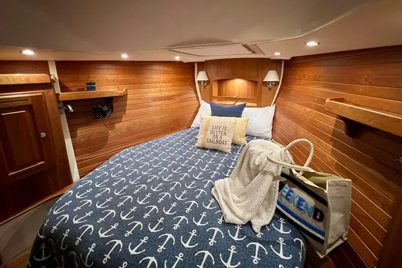 Slide: The Image of Cozy cabin interior of 2017 Tartan 4300 sailboat with nautical-themed bedding. - 16