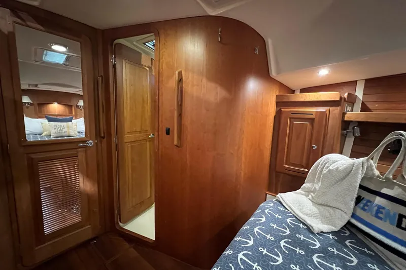 Slide: The Image of Luxurious 2017 Tartan 4300 yacht interior with wooden cabinetry and cozy bedding. - 17