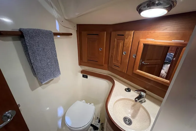 Slide: The Image of Luxurious 2017 Tartan 4300 yacht bathroom with wooden cabinets and modern fixtures. - 19