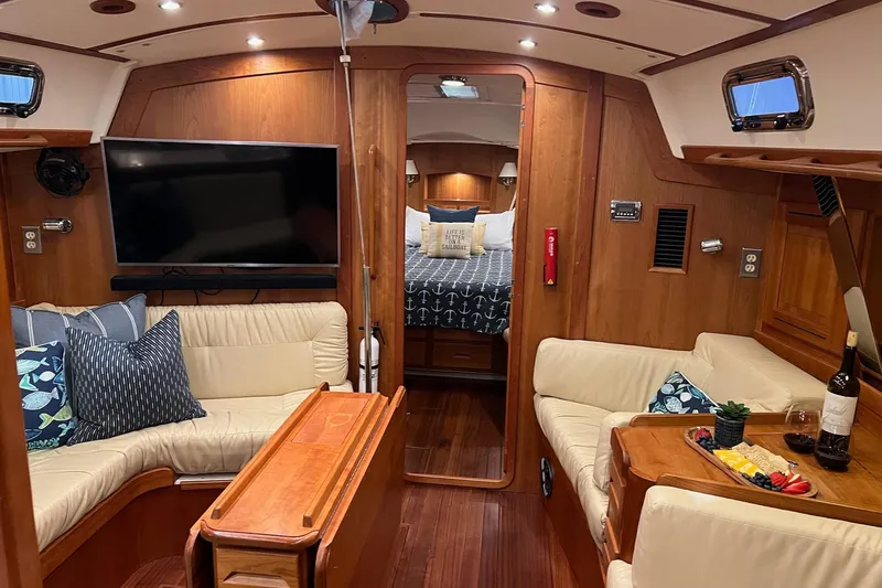 Slide: The Image of Luxurious 2017 Tartan 4300 yacht interior with cozy seating, TV, and elegant dining setup. - 21