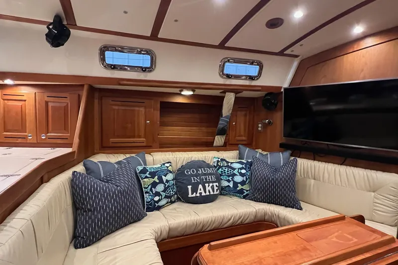 Slide: The Image of Luxurious 2017 Tartan 4300 yacht interior with cozy seating, decorative pillows, and wooden cabinetry. - 24