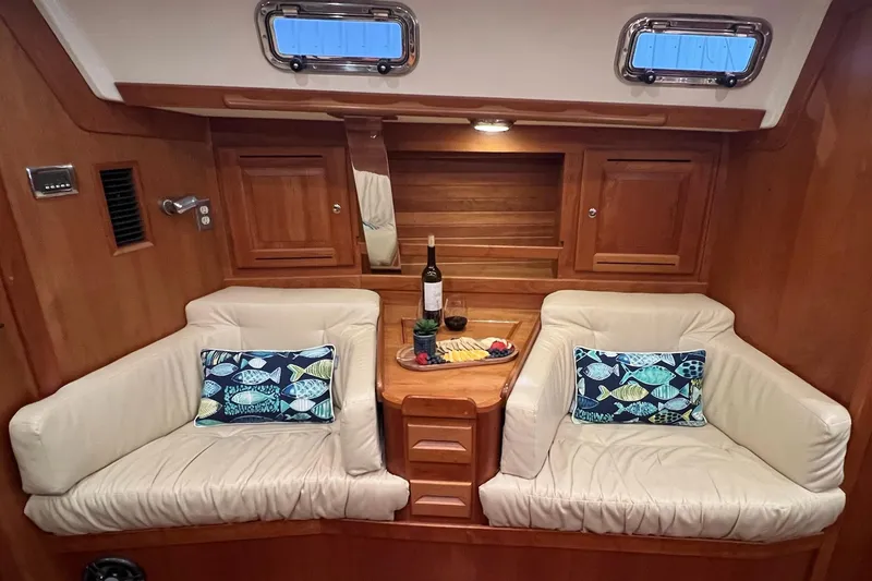 Slide: The Image of Luxurious 2017 Tartan 4300 yacht interior with cozy seating and nautical-themed pillows. - 26
