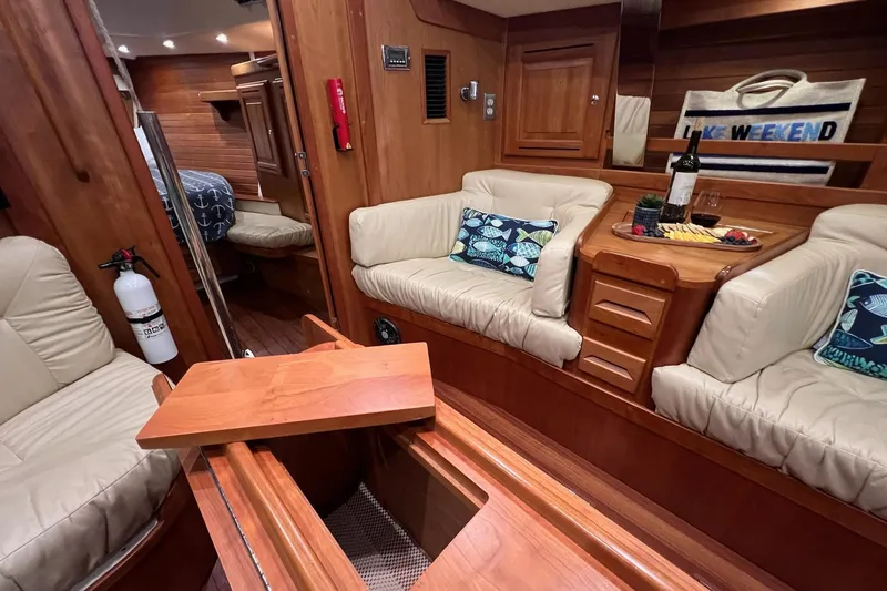 Slide: The Image of Luxurious 2017 Tartan 4300 yacht interior with cozy seating and elegant wooden finishes. - 28