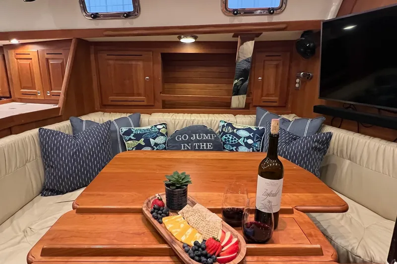 Slide: The Image of Luxurious 2017 Tartan 4300 yacht interior with wine, cheese platter, and cozy seating. - 32