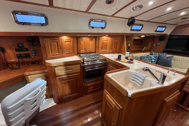 Slide: The Image of Luxurious 2017 Tartan 4300 yacht interior with wooden cabinetry and modern kitchen amenities. - 34
