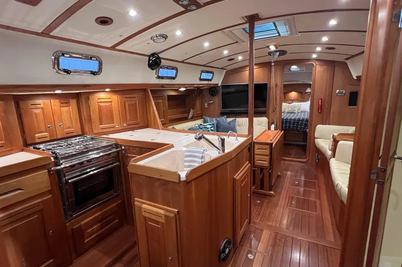 Slide: The Image of Luxurious 2017 Tartan 4300 yacht interior with wood finish, kitchen, and seating area. - 38
